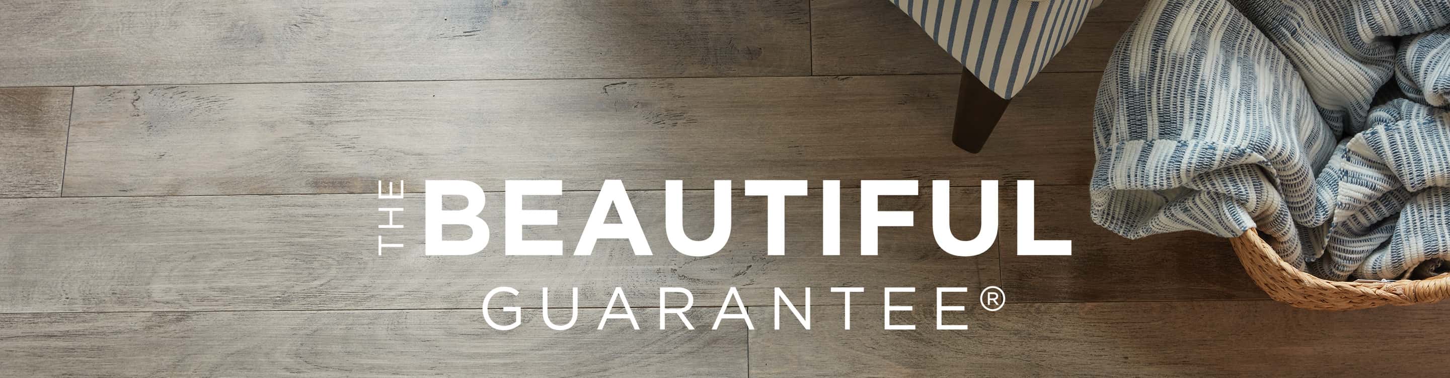The Beautiful Guarantee flooring warranty logo on a wood floor background